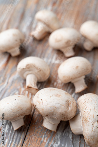 Bunch of champignons on light wooden table, close up photo for a market catalogue