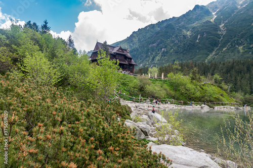 Landscape view on Eye of the Sea lake with mountain hut in Tatra mountains in the summertime.