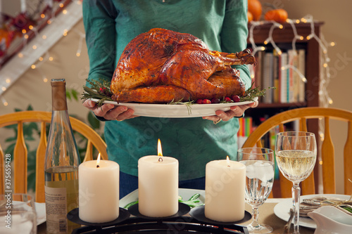 Thanksgiving: Woman Holding Platter With Traditional Turkey photo