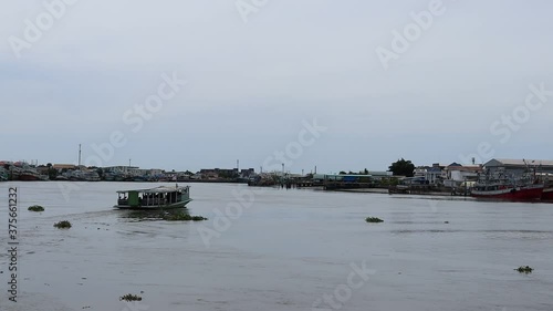 Ferry boat carrying passengers crossing the river to Mahachai port,. Samut Sakhon, Thailand. photo