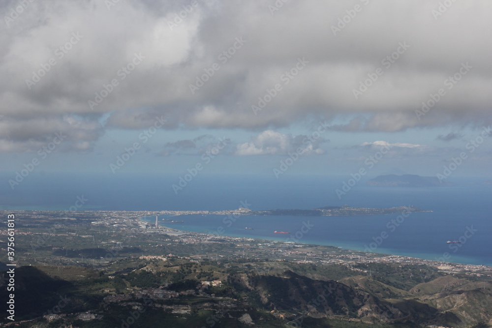 Clouds over the city, large view on Millazo and the Aeolian Islands