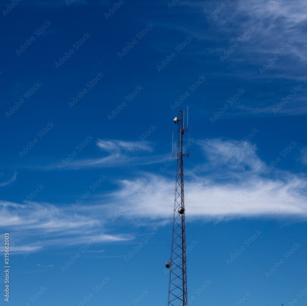 The tall metal tower with the clouds and the blue sky. The tall metal tower with the clouds and the blue sky.