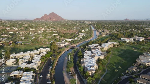 Aerial footage of central Phoenix following The Arizona Canal towards Camelback Mountain. photo