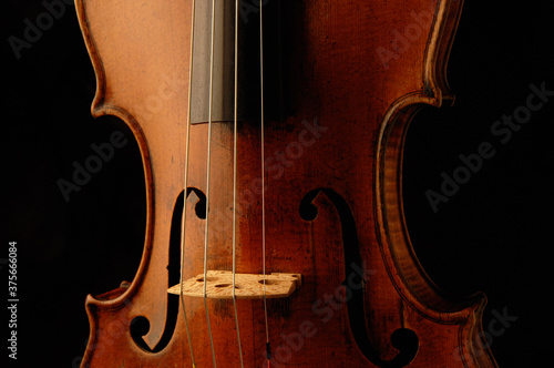 Vászonkép Antique Violin detail in moody lighting and black background