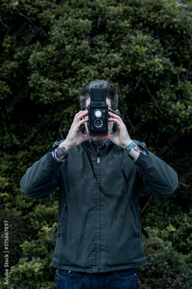 Man covering face with his camera. Man covering face with his camera.