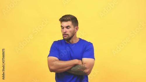 Young caucasian handsome man looking straight ahead, serious face, arms crossed, concept of goal and a purpose