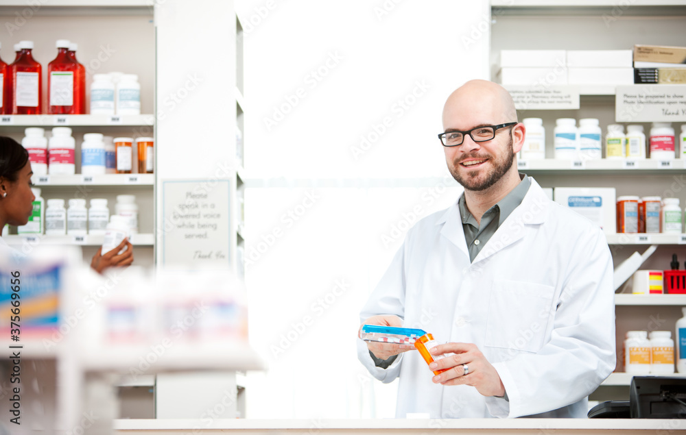 Pharmacy: Cheerful Pharmacist Fills Prescription Pharmacy: Cheerful Pharmacist Fills Prescription