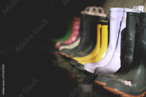 rain boots lined up along wall
