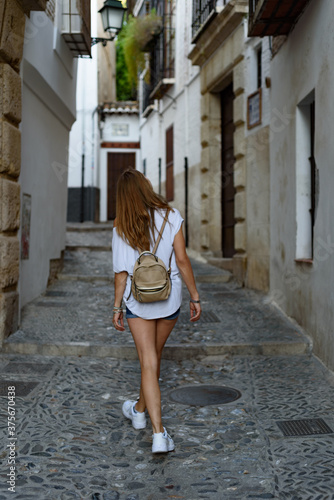 Shallow focus shot of a young female in an old city street © molinae