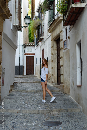 Shallow focus shot of a young female in an old city street