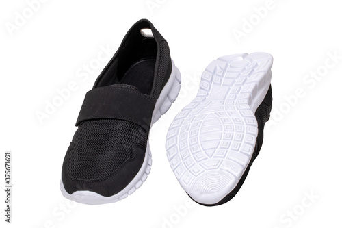 Mans black shoes. Close-up of a pair of black sneakers or sport shoes isolated on a white background. Elegant and trendy mens footwear. Macro.