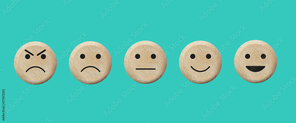 Fototapeta premium Customer feedback and satisfaction wooden icons. Basic emoticons set. Five facial expression of service evaluation - from positive to negative.
