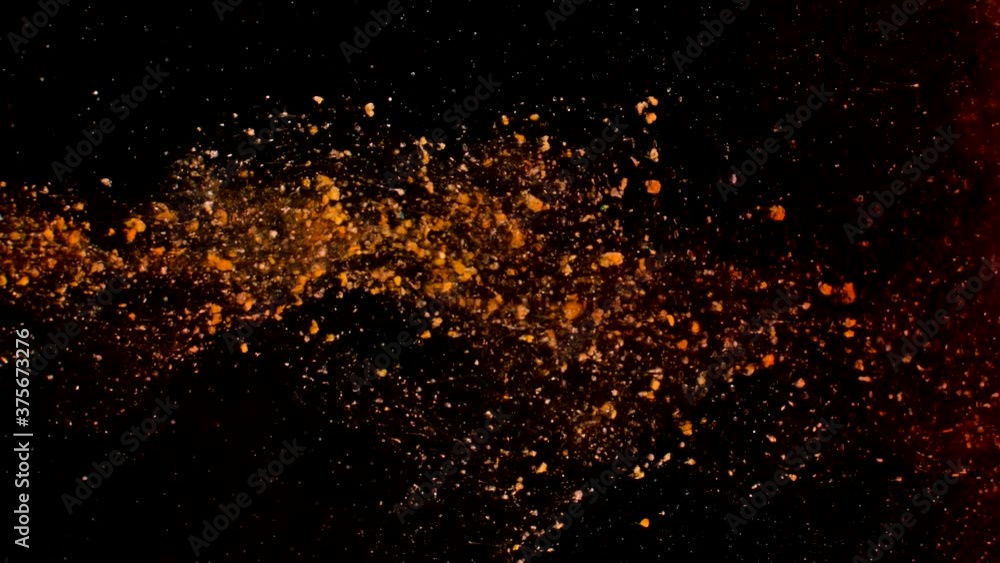 Abstract particles of orange liquid flow and float motion on black Abstract particles of orange liquid flow and float motion on black