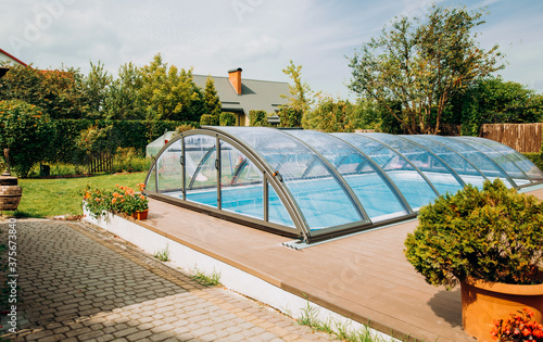 Seating area in the garden. Exquisite pool with transparent coating. photo