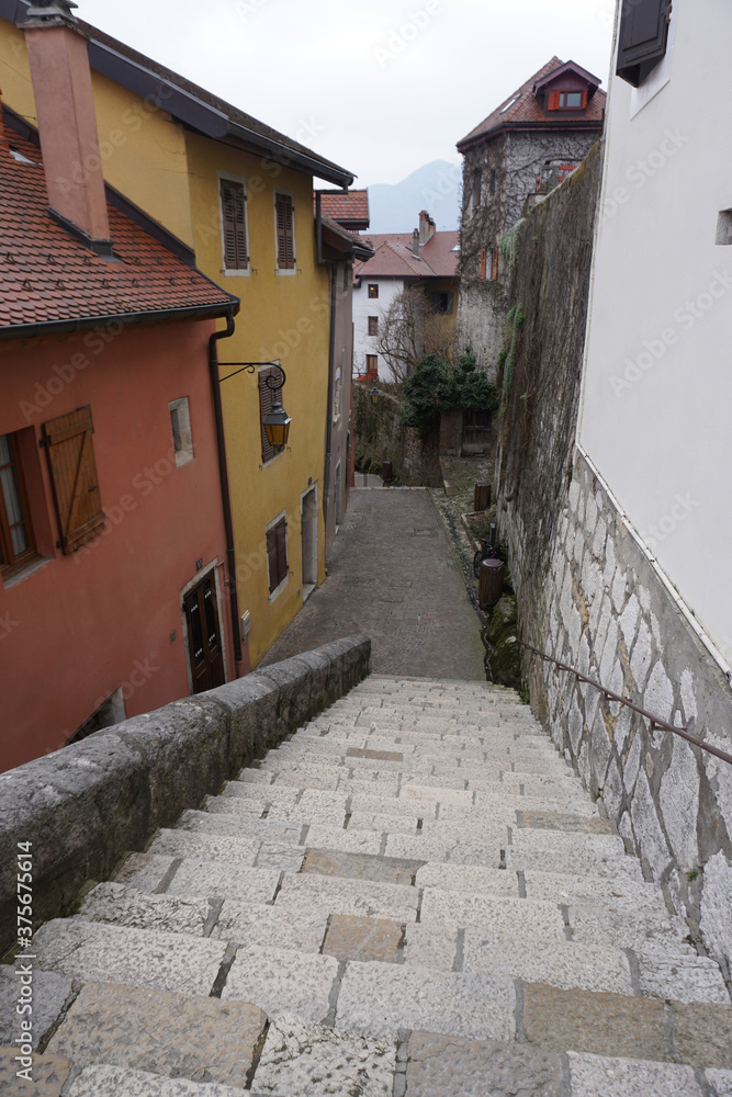 narrow street and stairway in the old town annecy, france with colorful buildings