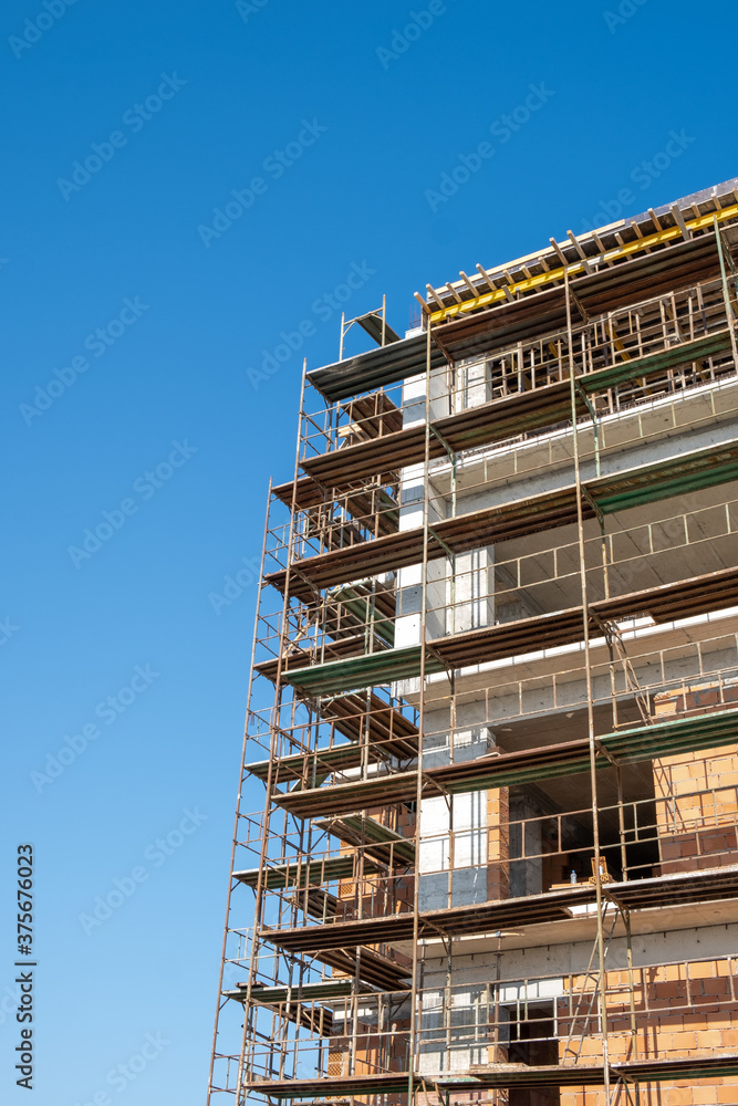 residential building construction site against a blue clear sky