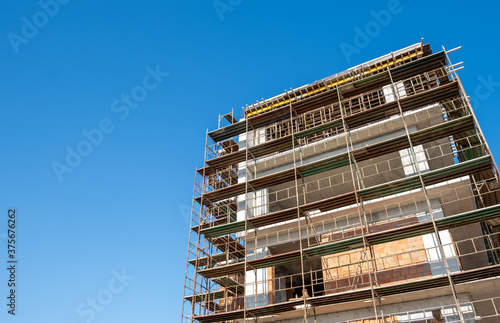 residential building construction site against a blue clear sky © Michalis Palis