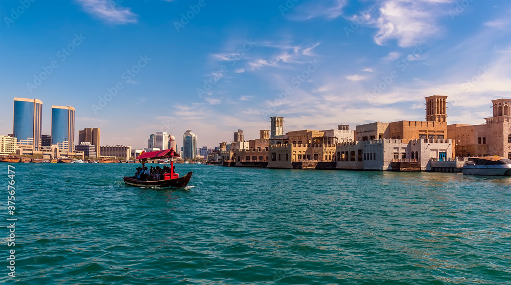 A view up the Dubai Creek towards the restored buildings of old Dubai in the UAE in springtime