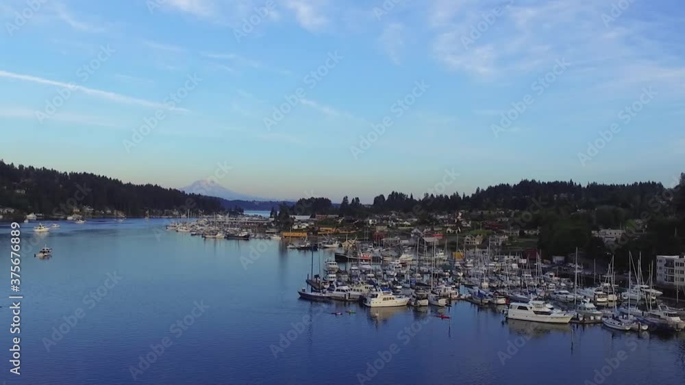 Luxury Yachts And Sailboats Moored At Gig Harbor Marina At Daytime By The Puget Sound In Pierce, Washington, USA. - aerial forward shot Luxury Yachts And Sailboats Moored At Gig Harbor Marina At Daytime By The Puget Sound In Pierce, Washington, USA. - aerial forward shot
