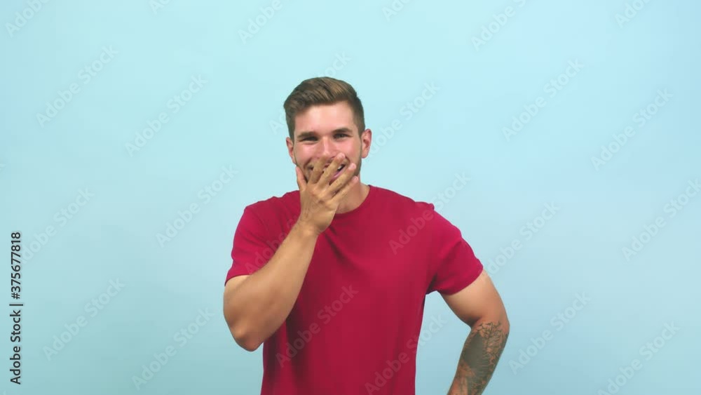 Young caucasian handsome man shouting and enjoying, looking with one eye, surprised and having fun Young caucasian handsome man shouting and enjoying, looking with one eye, surprised and having fun