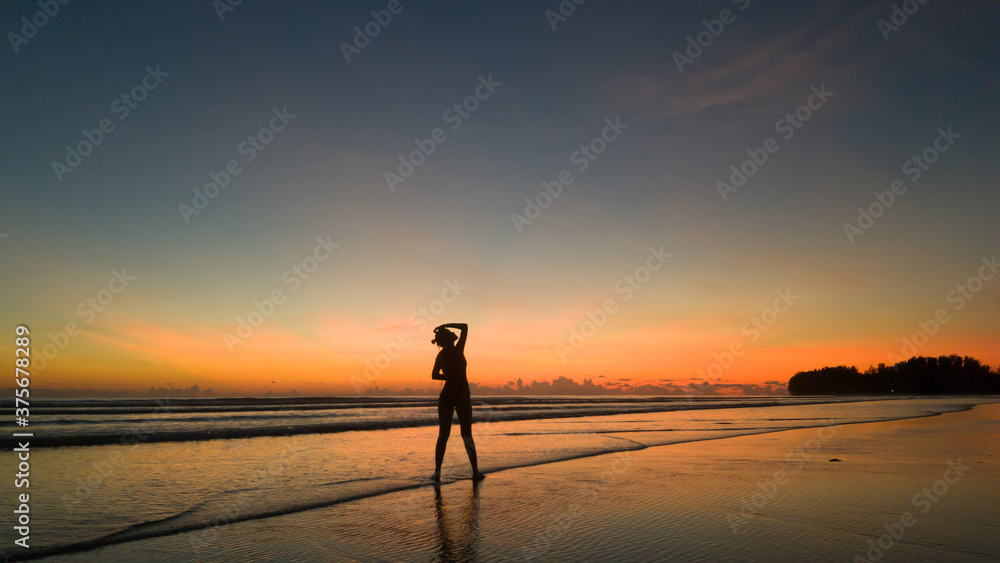 young woman exercising on the beach at beautiful sunset young woman exercising on the beach at beautiful sunset