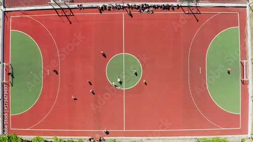 Ochakiv, Ukraine - July 27, 2020: Children playing football on outdoor field at Sportium camp, top view