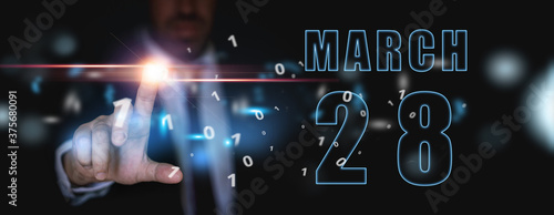 march 28th. Day 28 of month,advertising or high-tech calendar, man in suit presses bright virtual button spring month, day of the year concept