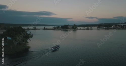 Wallpaper Mural Beautiful drone aerial shot of a boat driving through the lake of Peten Itza, Guatemala during sunset Torontodigital.ca