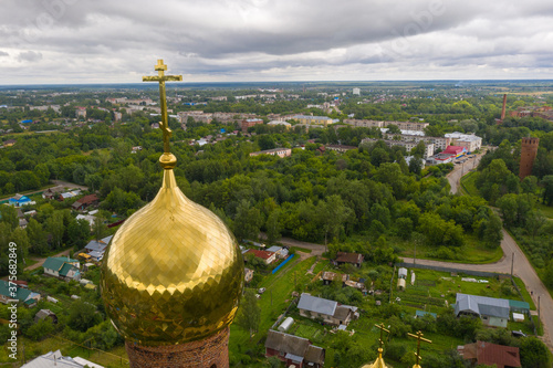 Golden dome with a cross of the bell tower of the Church of the Resurrection of Christ in Vichuga, Ivanovo region. Russia. photo