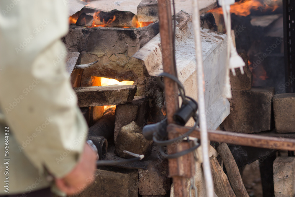 blacksmith working in the fireplace. Mamshit market. The Israel national reserve. blacksmith working in the fireplace. Mamshit market. The Israel national reserve.