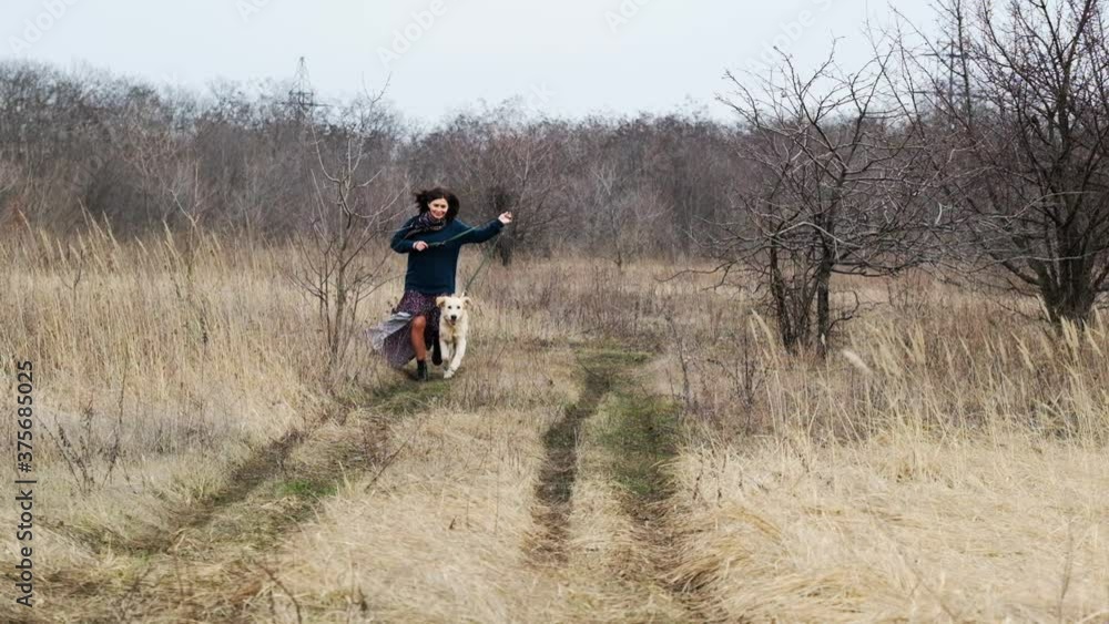 Happy woman running with cute dog on nature Happy woman running with cute dog on nature