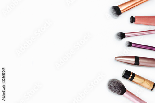 Nacre beauty make-up accessories brush set and cosmetics flat lay composition on white background, top view.