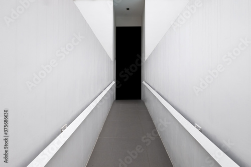 Concrete corridor with white wall and granite tile