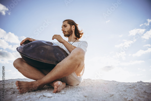 handpan in the hands of a musician. Music background for alternative contemporary music for meditation and relaxation. Copy space photo