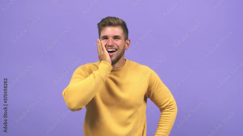 Young caucasian handsome man shouting and enjoying, looking with one eye, surprised and having fun Young caucasian handsome man shouting and enjoying, looking with one eye, surprised and having fun