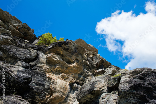Rocks in the mountains with blue cloudy sky