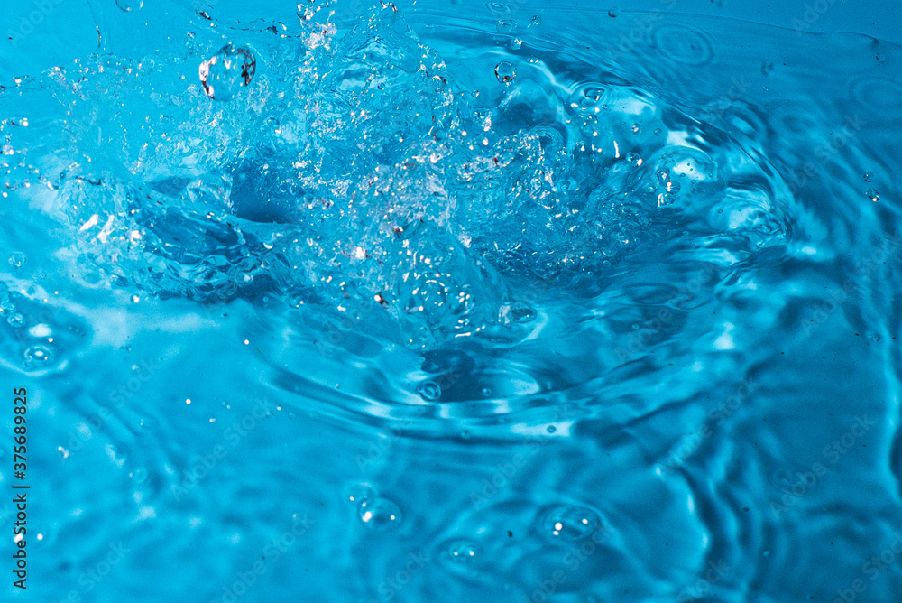 splash of water on a blue background. Abstract wallpaper splash of water on a blue background. Abstract wallpaper