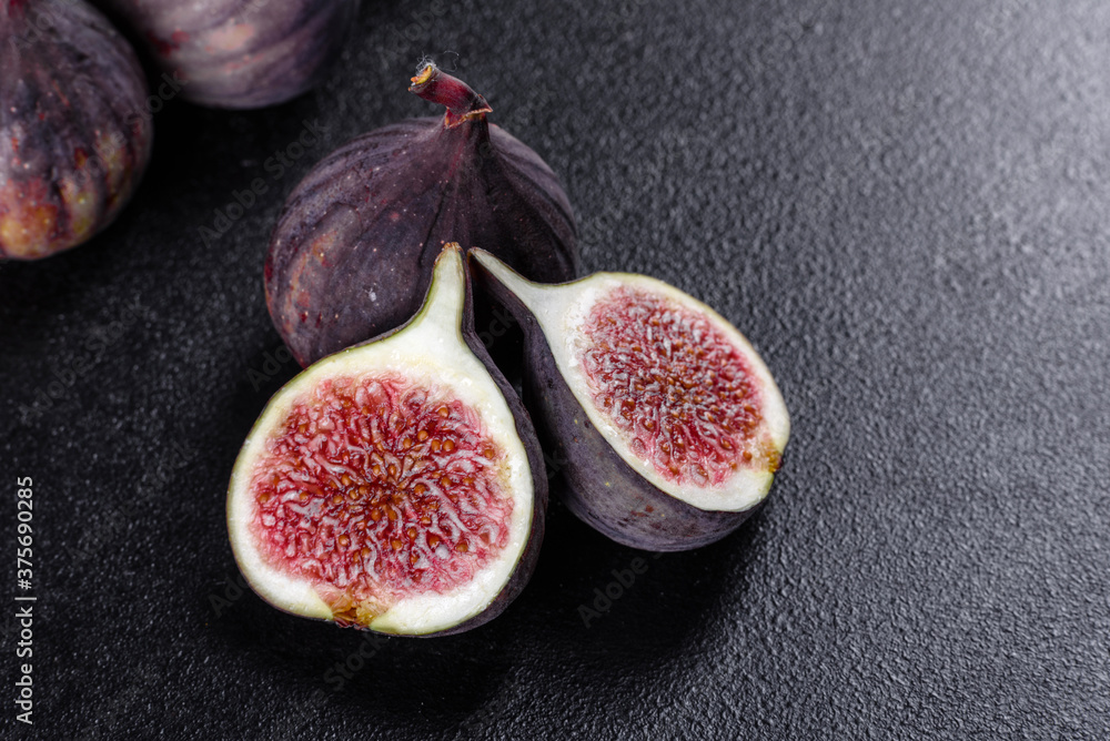 Fresh ripe figs on a dark concrete background. Harvesting figs Fresh ripe figs on a dark concrete background. Harvesting figs