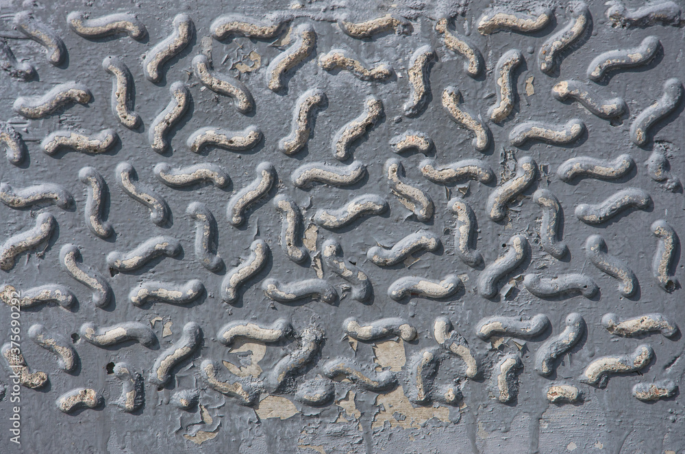Texture of an old gray wall of a building with an abstract pattern, cracks and smudges close-up. Texture of an old gray wall of a building with an abstract pattern, cracks and smudges close-up.