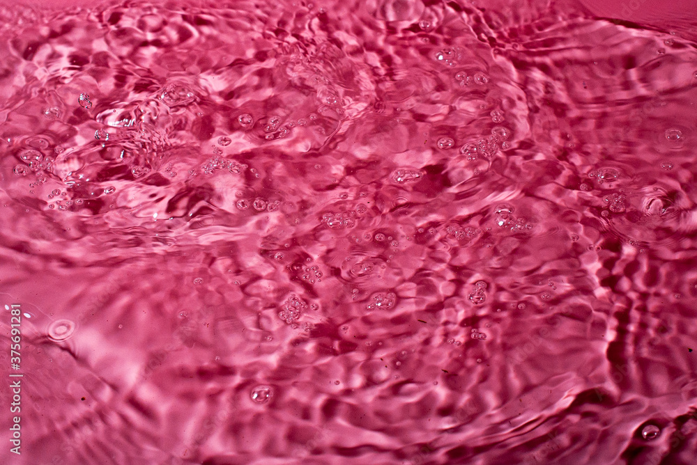 splash of water on a red background. Abstract wallpaper splash of water on a red background. Abstract wallpaper
