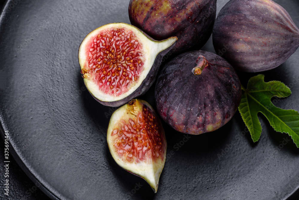 Fresh ripe figs on a dark concrete background. Harvesting figs Fresh ripe figs on a dark concrete background. Harvesting figs