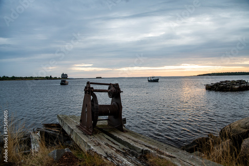 beautiful landscape with old wooden port  stones and sea at sunrise