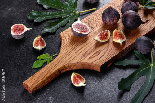 Fresh ripe figs on a dark concrete background. Harvesting figs