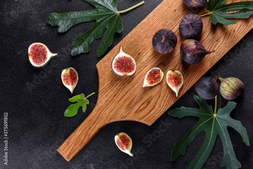 Fototapeta Naklejka Na Ścianę i Meble -  Fresh ripe figs on a dark concrete background. Harvesting figs