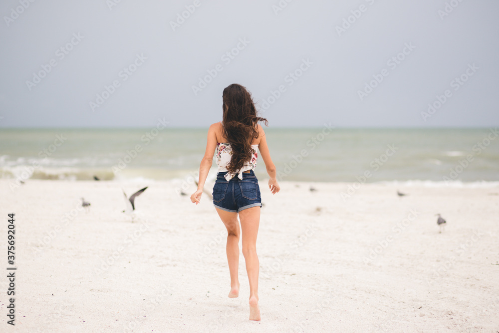 Girl running on the beach in Marco Island 
