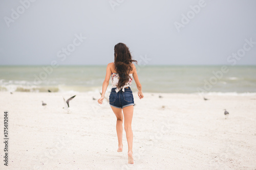 Girl running on the beach in Marco Island  