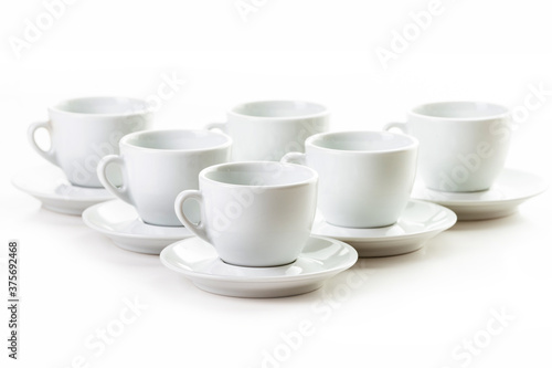 Six white coffee cups and saucers
