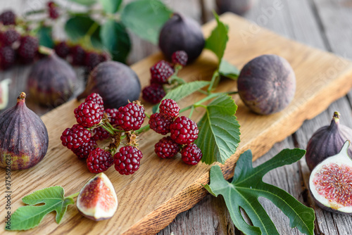 Fototapeta Naklejka Na Ścianę i Meble -  Fresh juicy figs and blackberries on a dark background