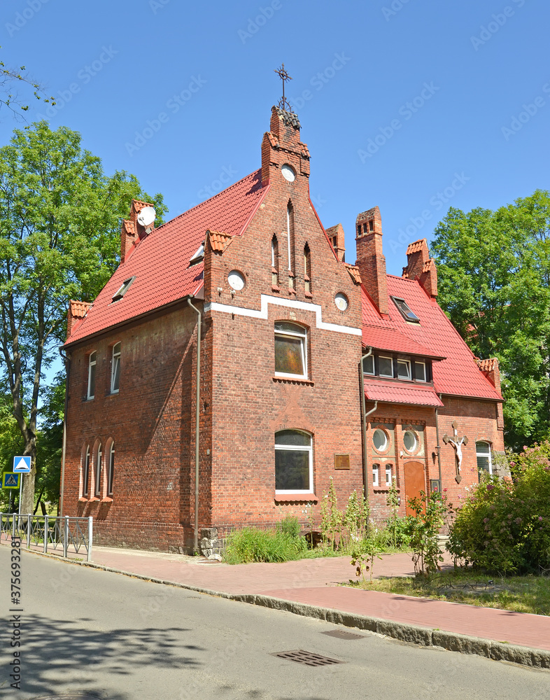 The building of the Roman Catholic parish of the Blessed Name of the Virgin Mary (the former home of the pastor of the Catholic Church Pillau, 1910). Baltiysk, Kaliningrad region The building of the Roman Catholic parish of the Blessed Name of the Virgin Mary (the former home of the pastor of the Catholic Church Pillau, 1910). Baltiysk, Kaliningrad region