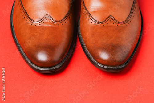 Men shoes close-up on a red background. Stylish shoes and accessories. Men's blog